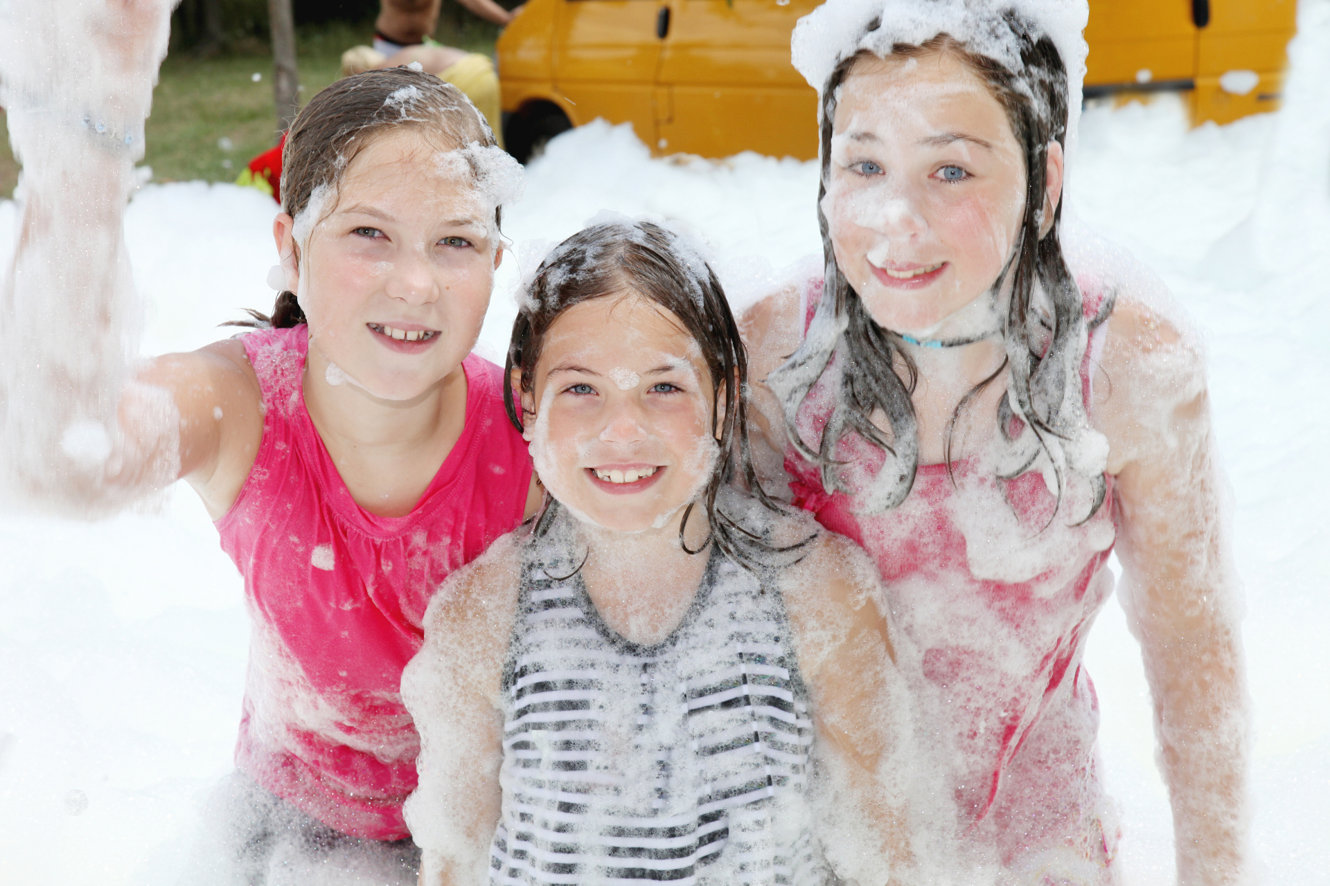 Friends smiling together in fresh party foam