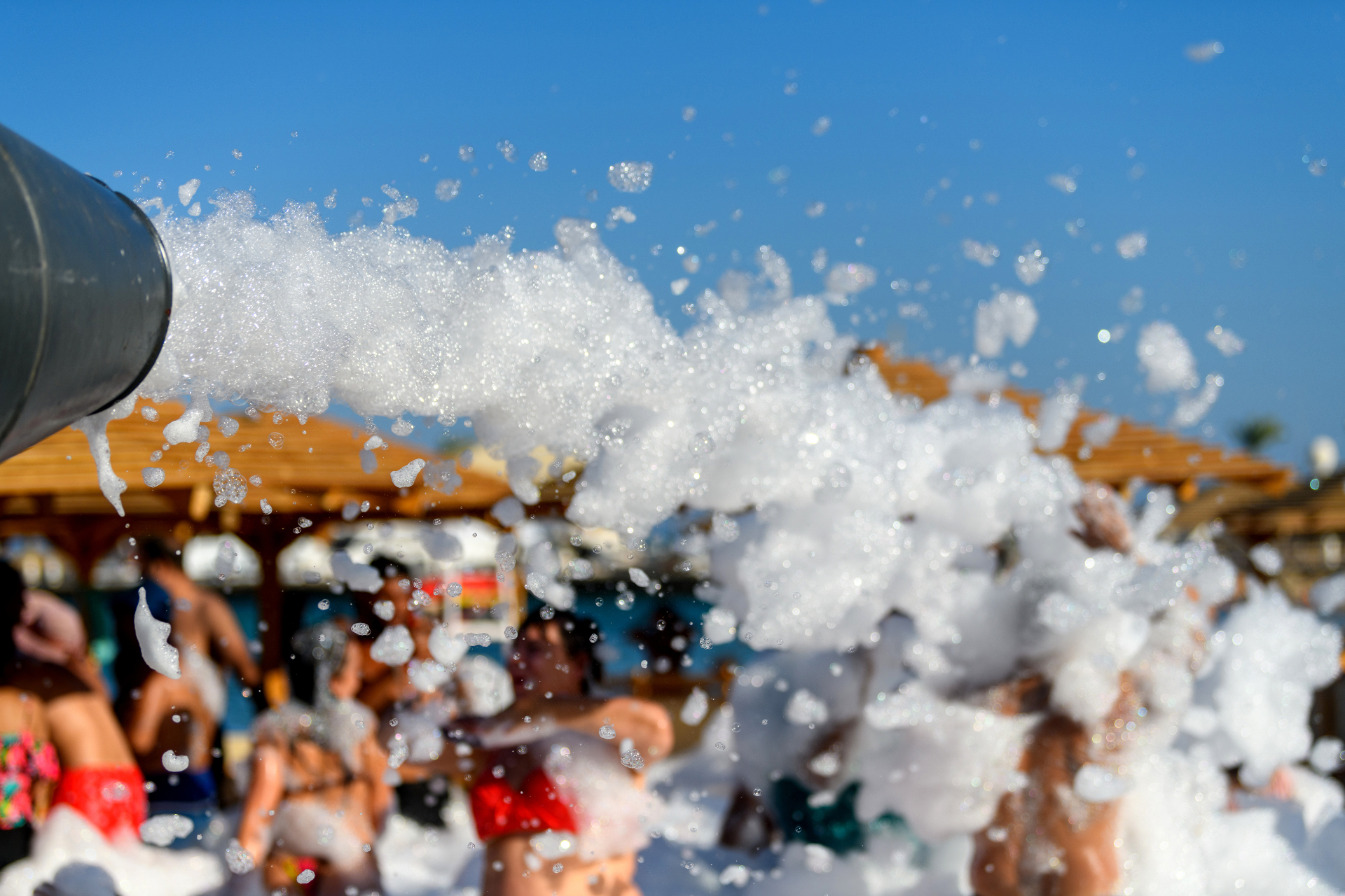 Coastal Foam Party Rentals foam cannon filling an outdoor party with foam