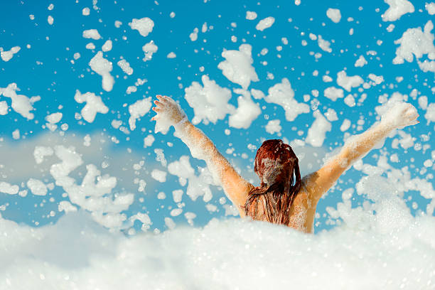 A child celebrating under flying foam